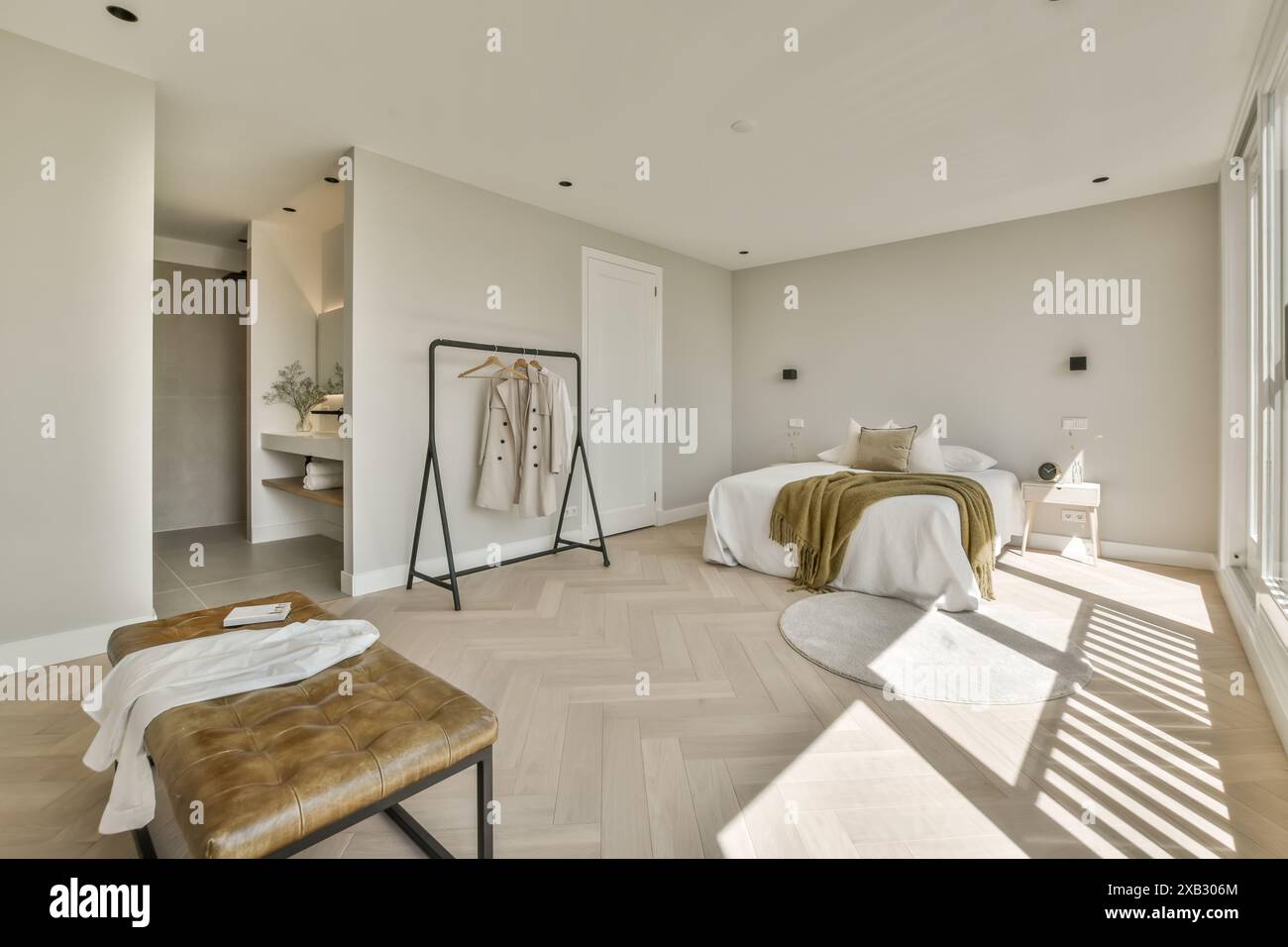 A spacious modern bedroom featuring natural light, a herringbone ...