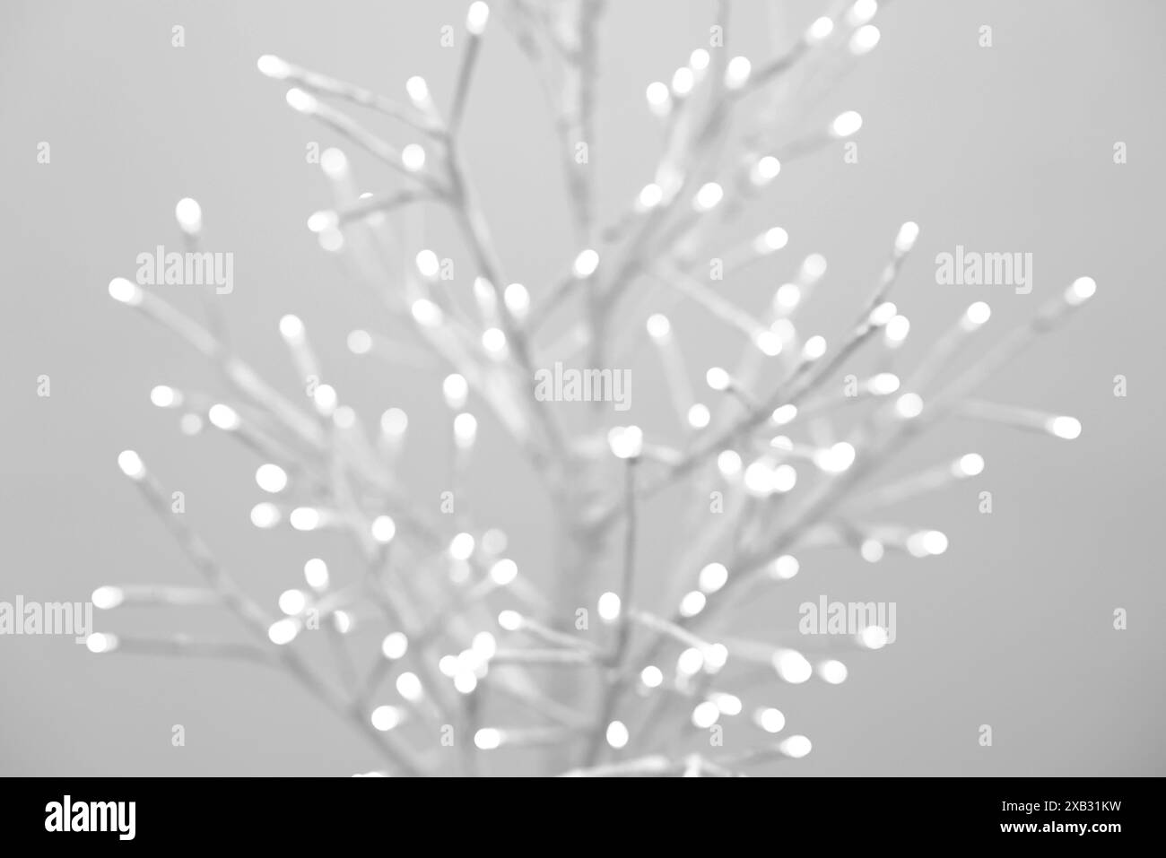 Decorative tree with lights on beige background, blurred view Stock ...