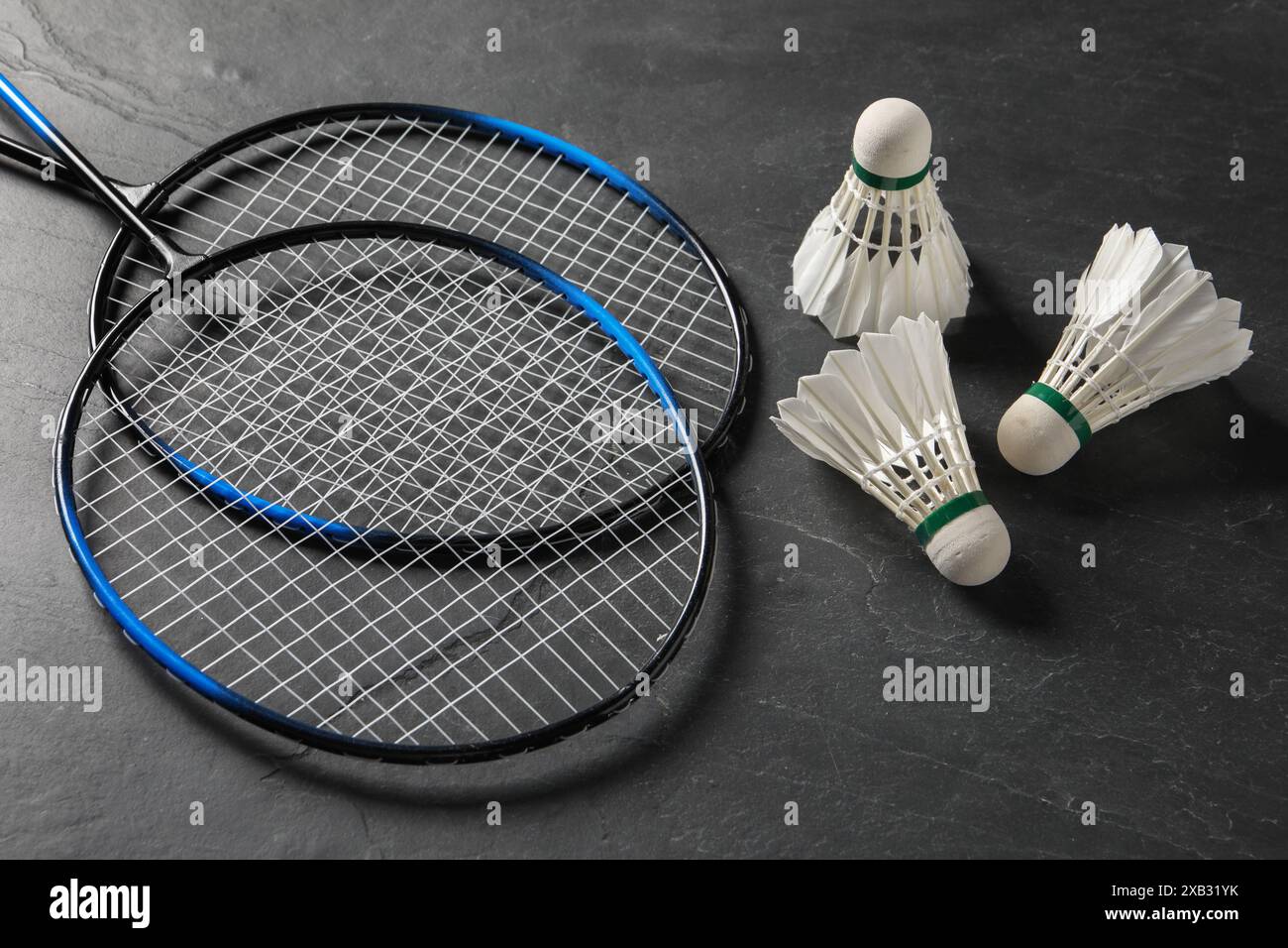 Feather badminton shuttlecocks and rackets on grey textured table Stock Photo