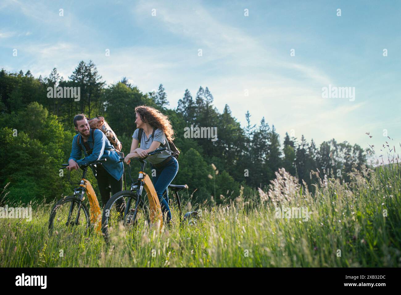 Travellers couple going on e-bike ride in nature. Tourist riding ...