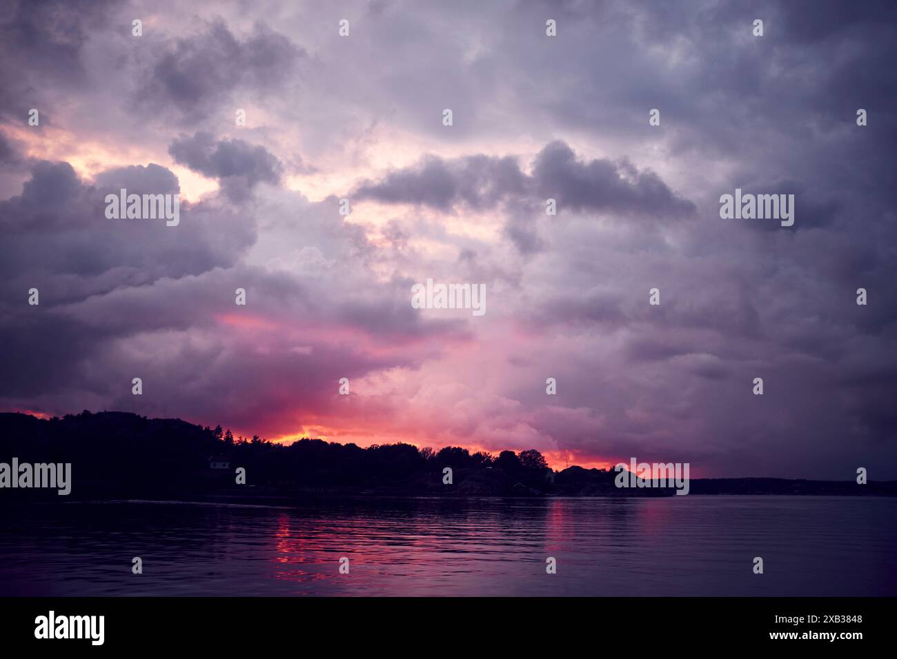 Lake under cloudy sky during dusk Stock Photo - Alamy