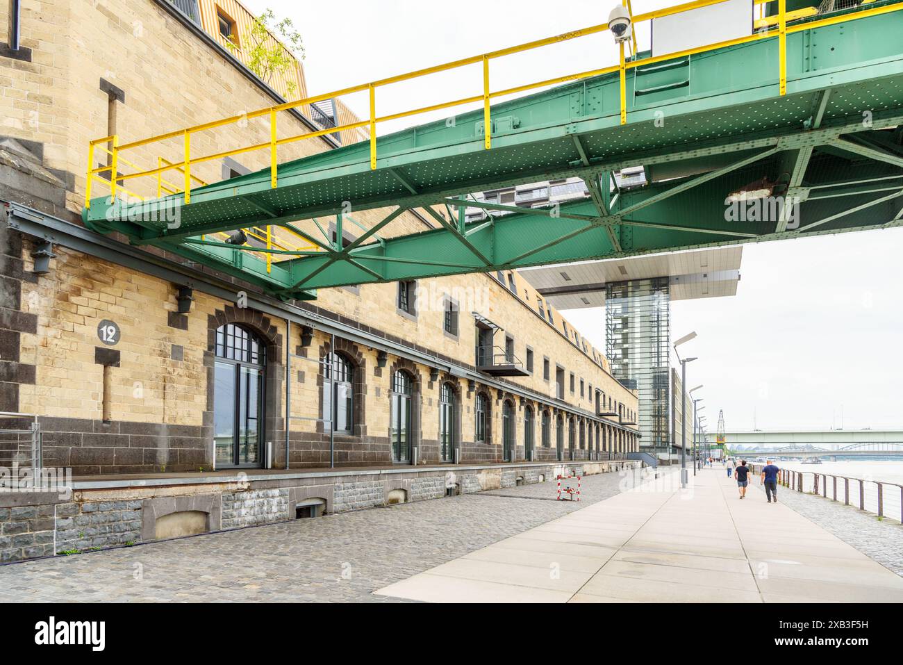 Curated visual reference: Visual Reference: Old Warehouses Converted Into Offices Along A Riverbank Path Stock