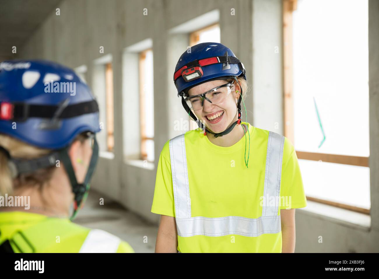 Smiling female engineers discussing while standing at construction site Stock Photo