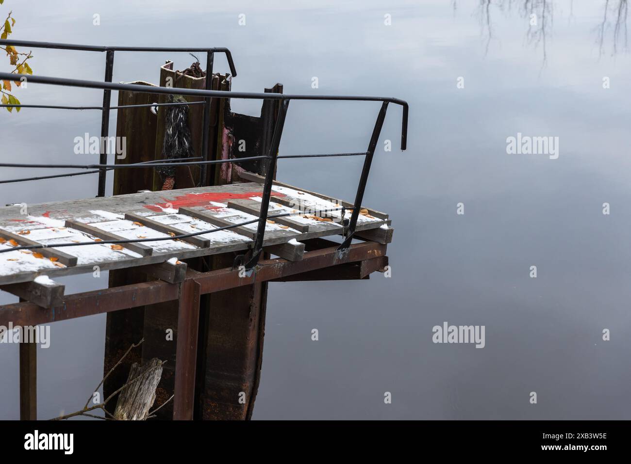 Small pier covered with snow at Ladoga lake coast on a winter day Stock Photo