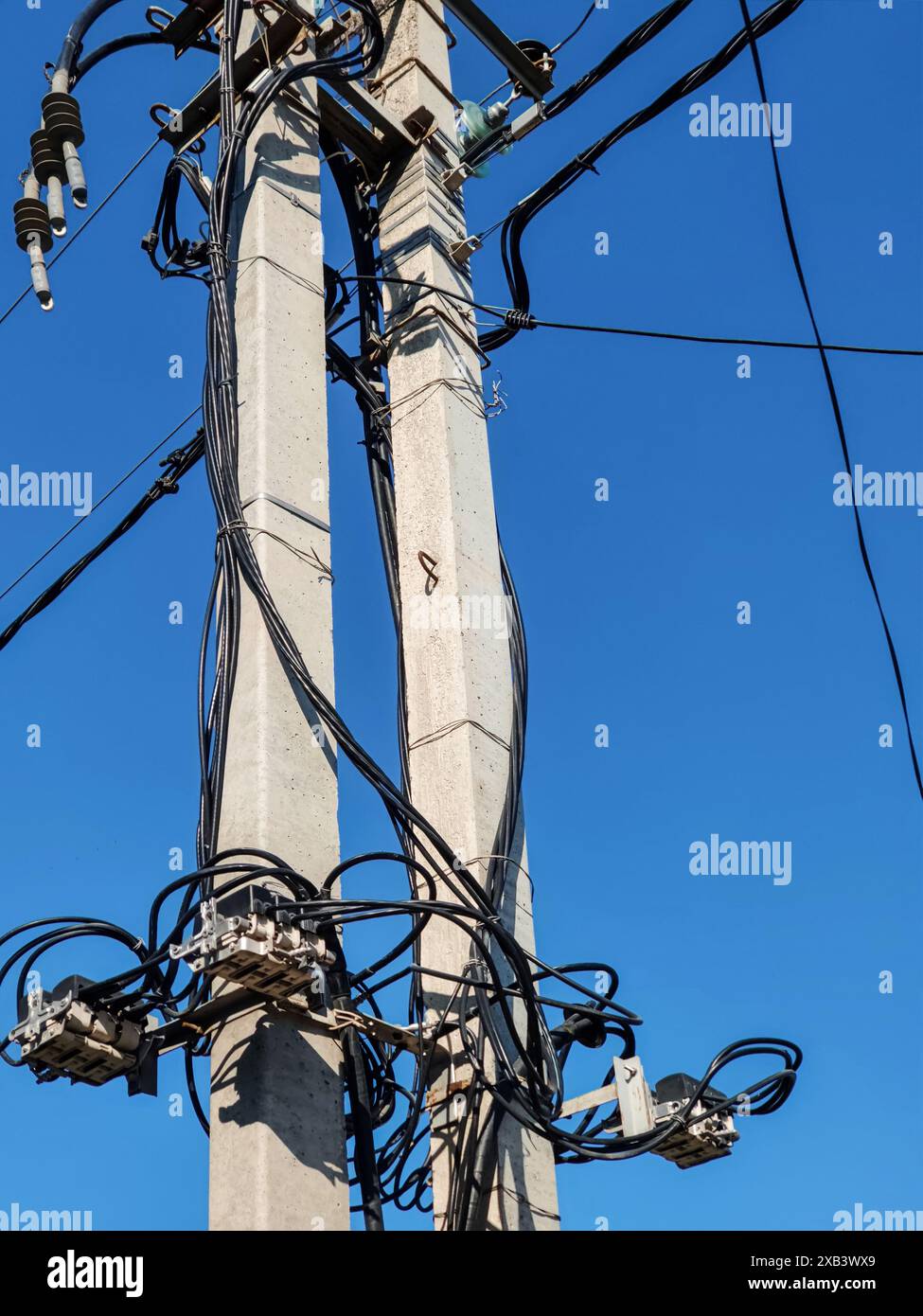Concrete pillars with electrical wires, coils of cables and switching