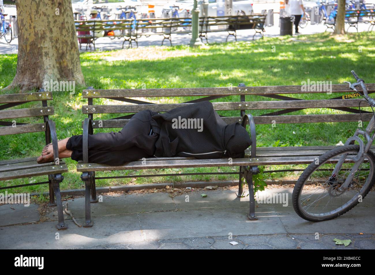 Homeless man sleeps on a bench at Foley Square at Center Street in ...