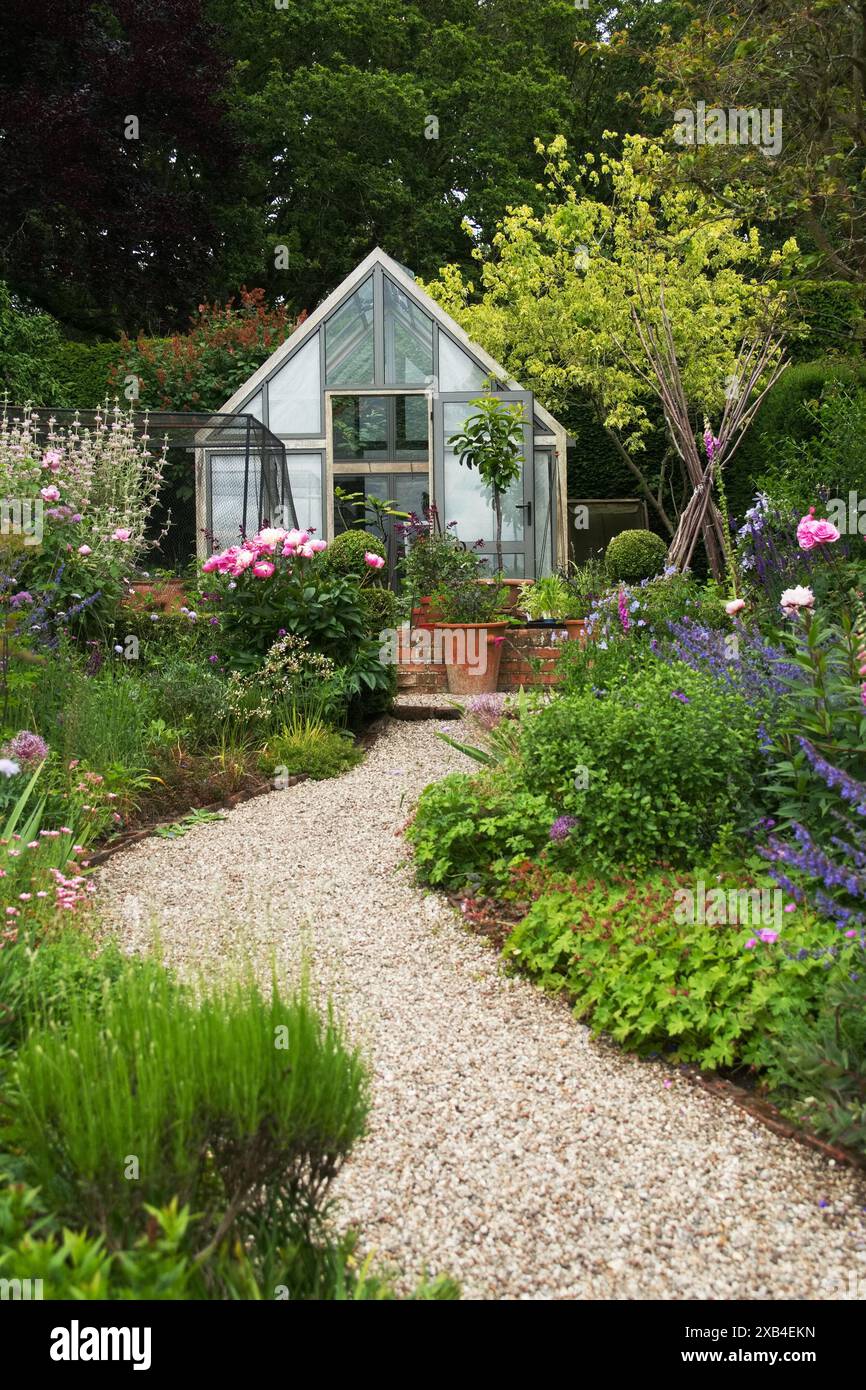 English Country Garden - Gravel path winds through vibrant flowers ...