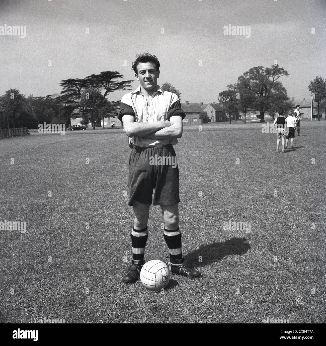 1953, historical, pre-season, training ground, Enfield Highway F. C, London, England, UK, footballer poses for picture in kit of the era, long shorts and leather boots with high ankle. Stock Photo
