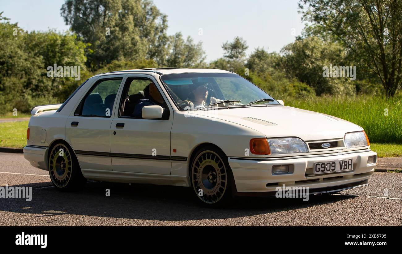 Stony Stratford,UK - June 2nd 2024:1989 white Ford Sierra sapphire cosworth classic  car driving on a British country road Stock Photo