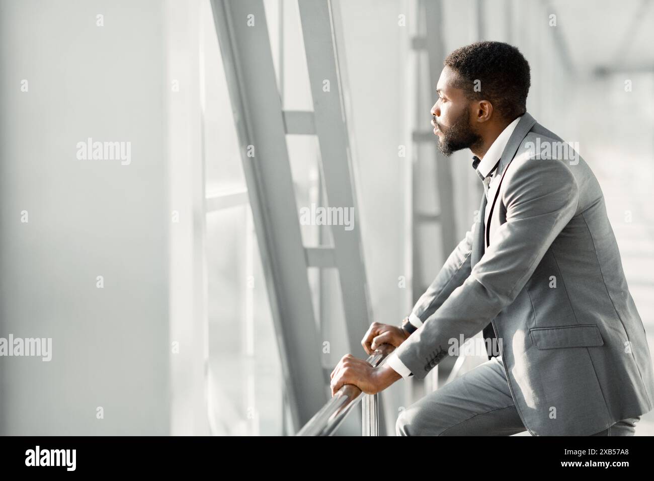 Feeling Relaxed. Confident Businessman Looking Through Window Stock Photo
