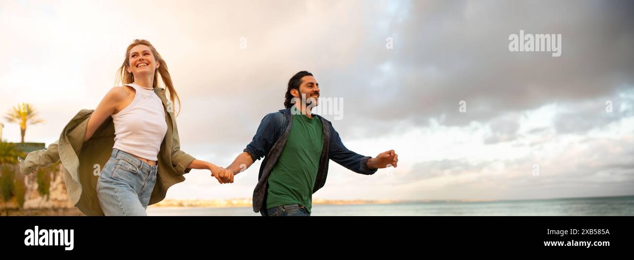 Romantic multiethnic couple holding hands hi-res stock photography and ...