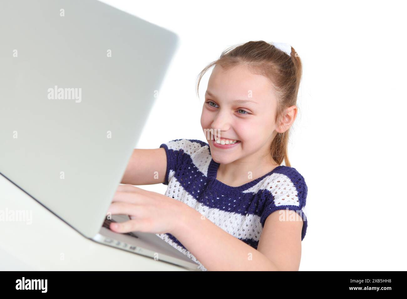 cheerful preteen girl using laptop on white background Stock Photo - Alamy