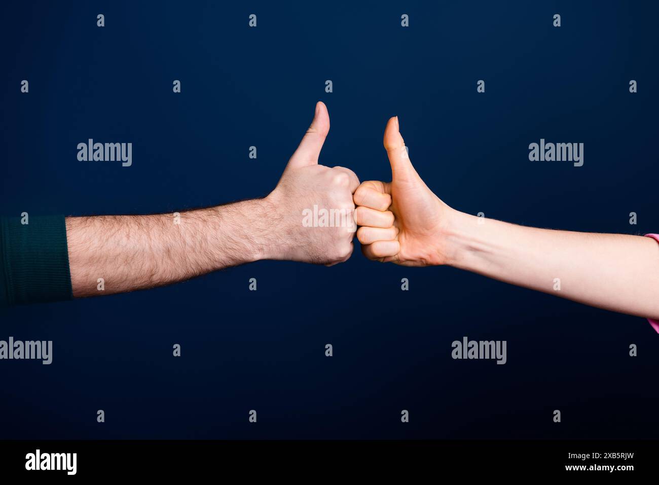 Photo of two people making thumb up sign bumping isolated dark color ...