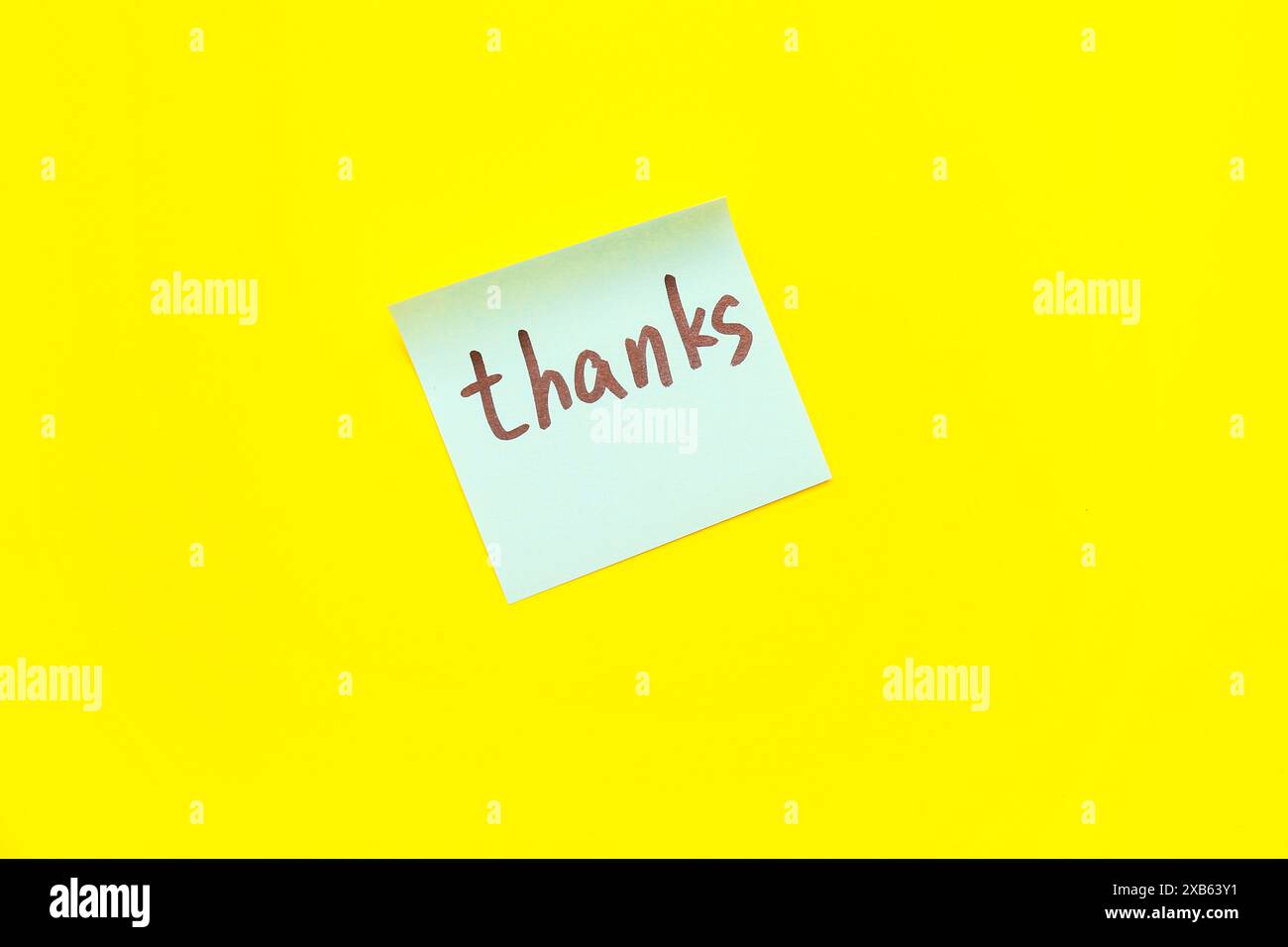 Sticky note with word THANKS on yellow background Stock Photo