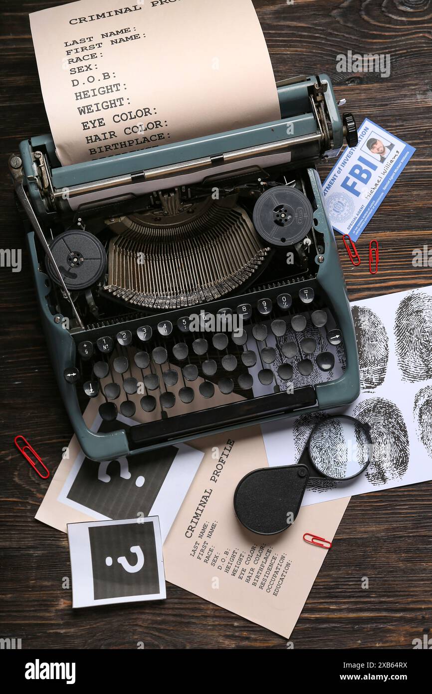 Retro typewriter, criminal files and document of FBI agent on dark ...