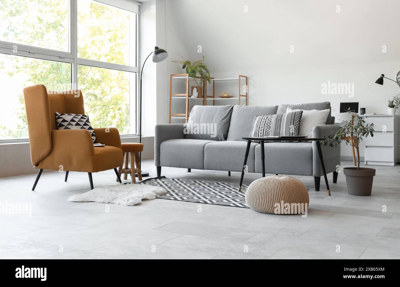 Interior of light living room with grey sofa, table and armchair Stock ...