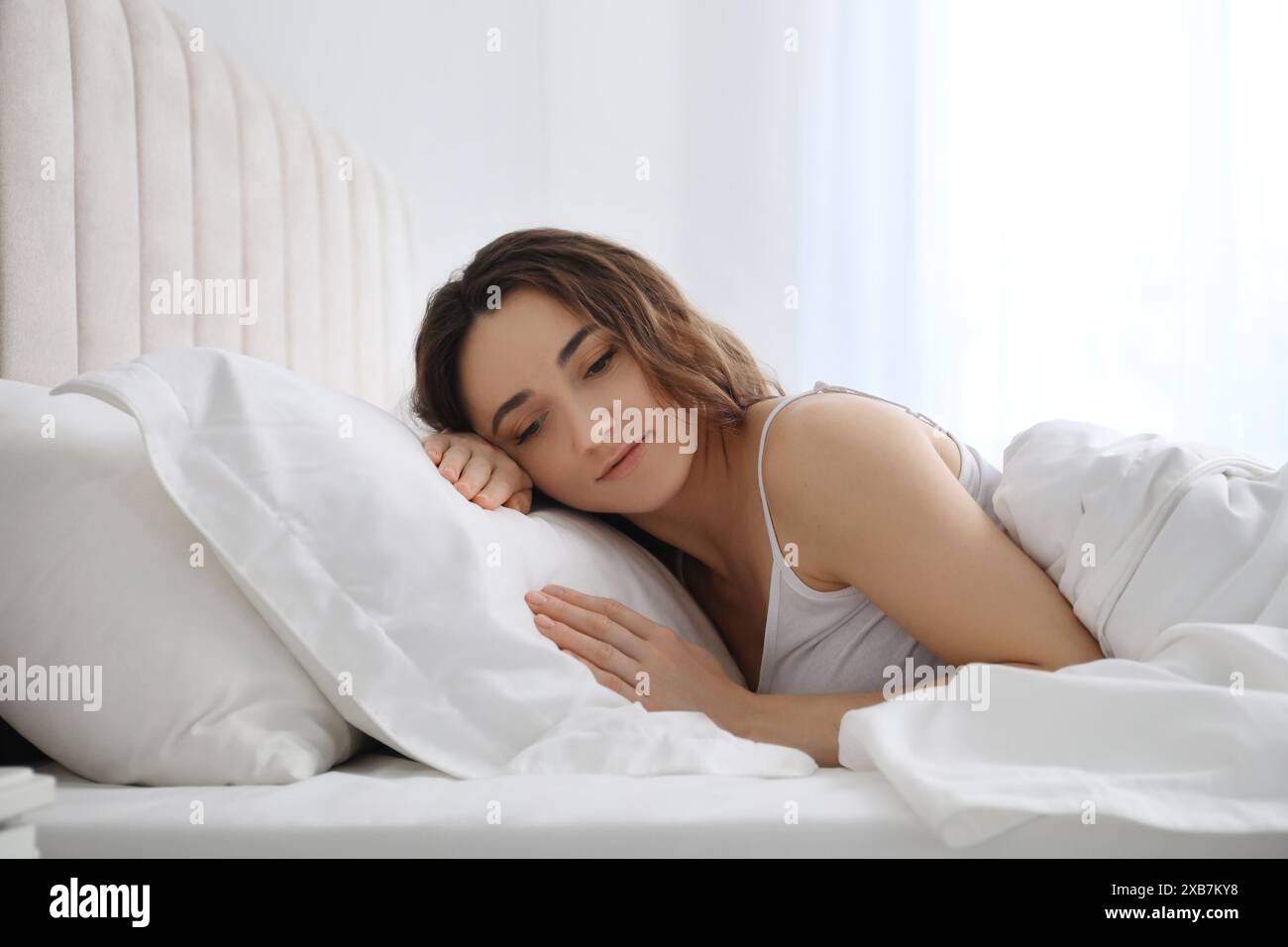 Beautiful woman lying in bed hi-res stock photography and images - Alamy