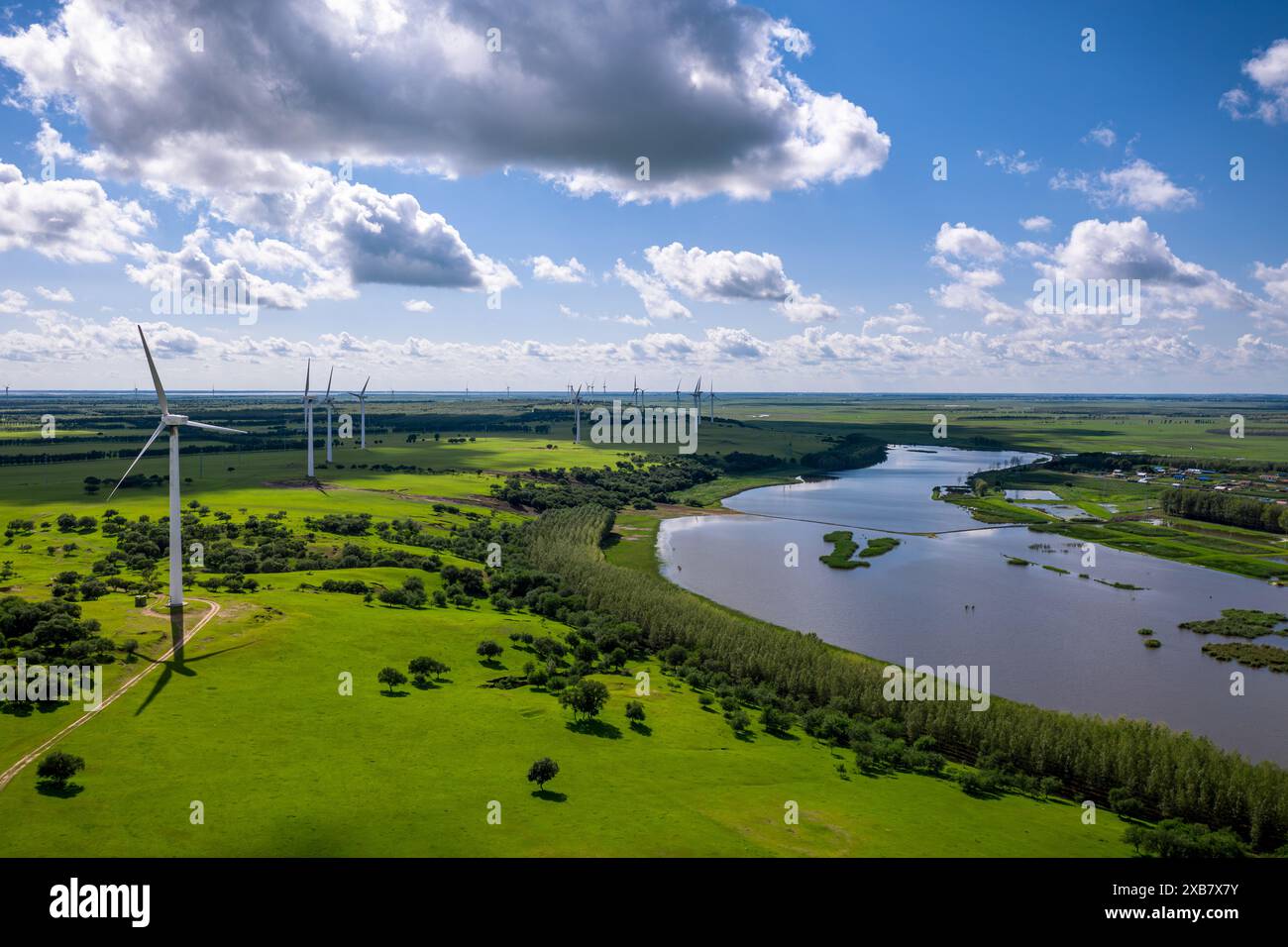 An aerial view of wind turbines in a green field on a sunny day Stock ...
