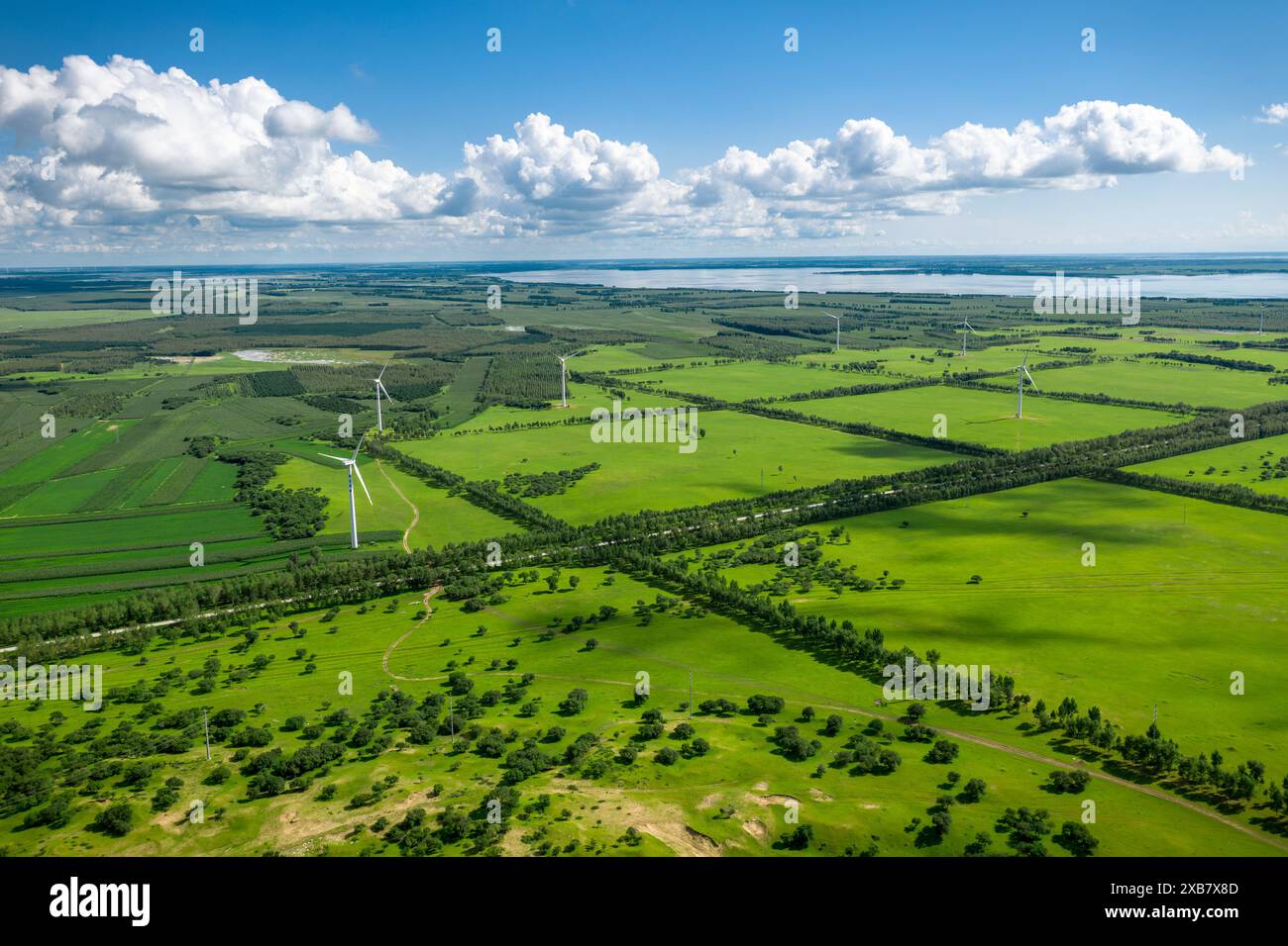 An aerial view of wind turbines in a green field on a sunny day Stock ...