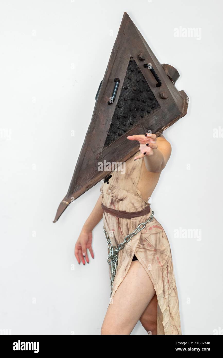 Pyramidal Female Figure A female cosplayer in a horror character costume of Pyramid Head from ...