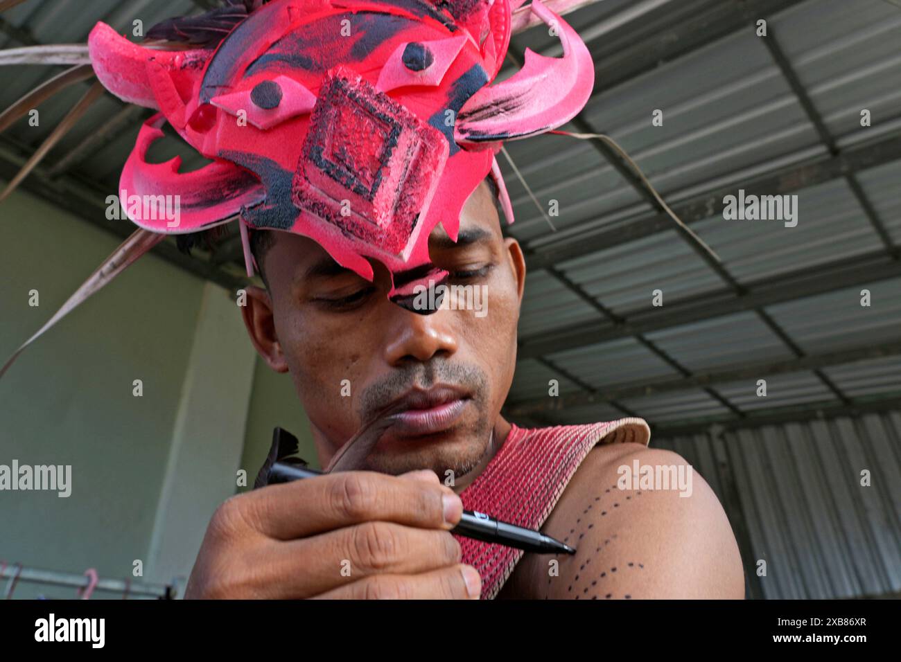 Neak Men A man paints his body before participating in the He Neak Ta rituals in ...