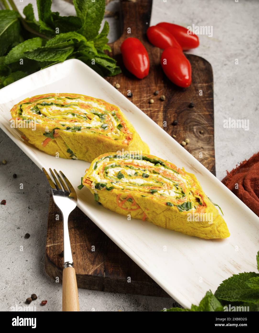 A variety of food with tomatoes and peppers on a plate Stock Photo