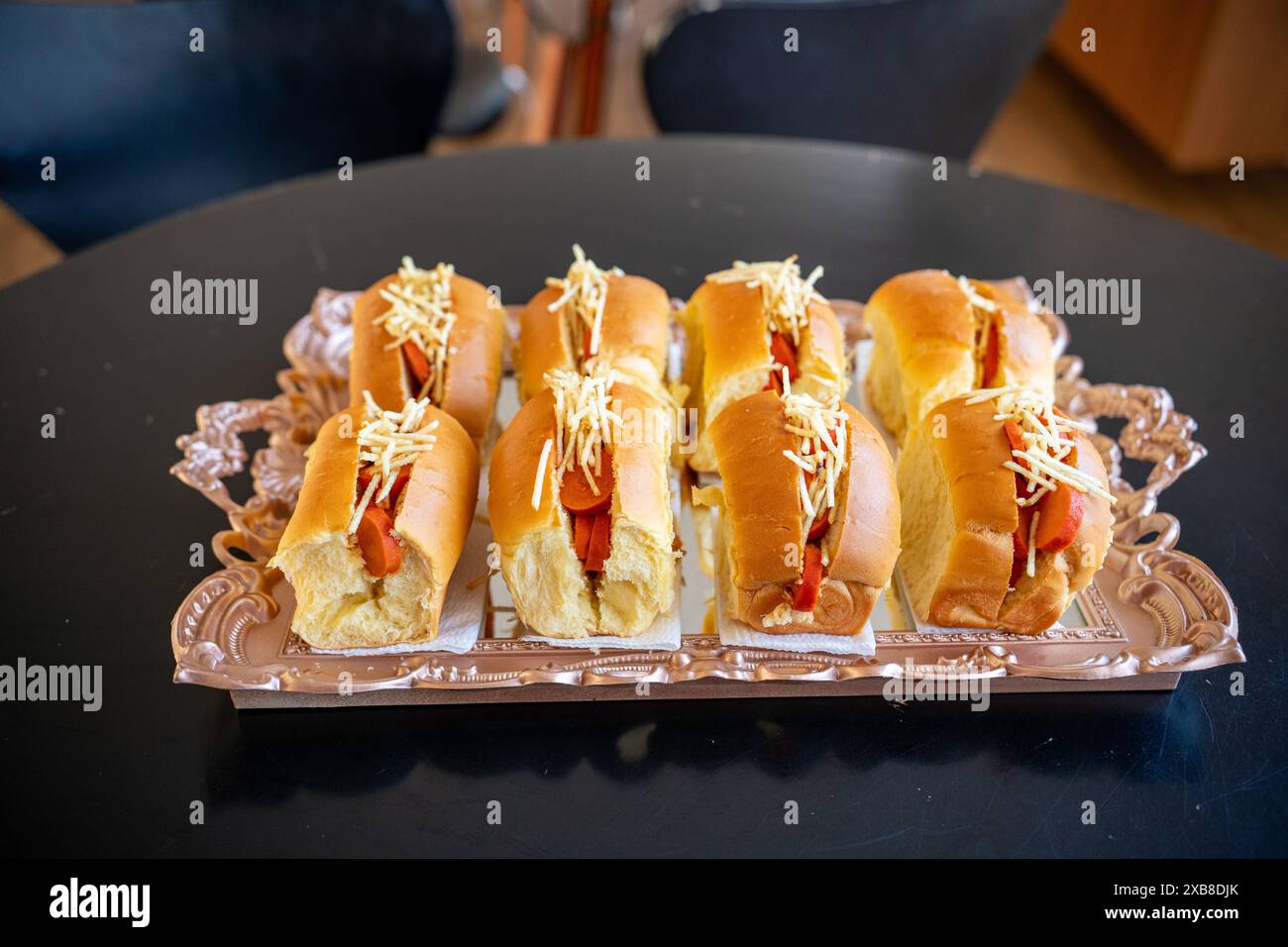 A plate of hot dogs smothered in toppings Stock Photo