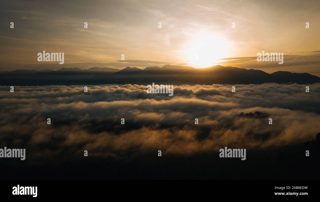 Clouds during sunrise above mountain hi-res stock photography and ...