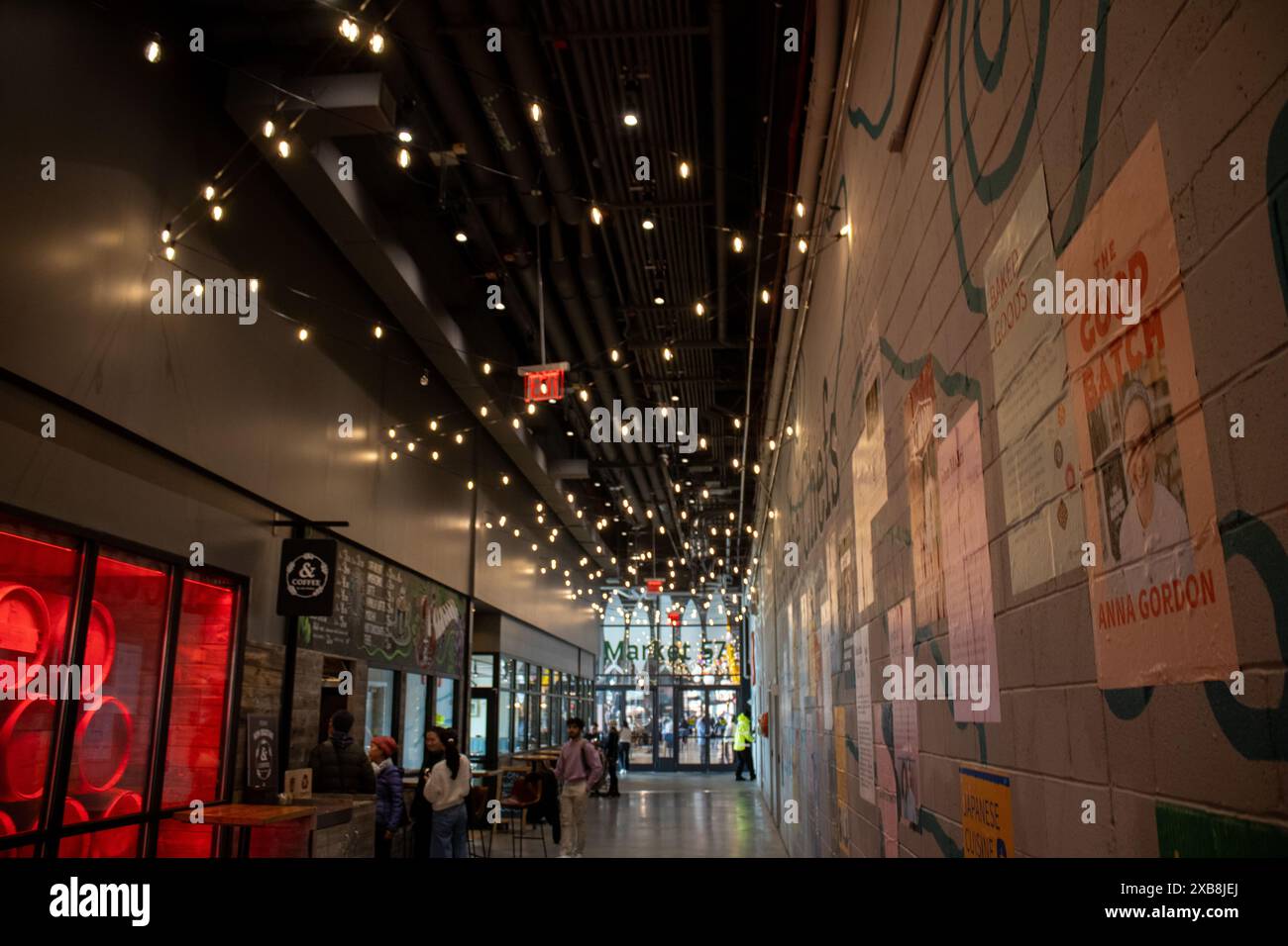 An illuminated walkway adorned with wall-mounted lights. Pier 57 Google New York lights Stock Photo