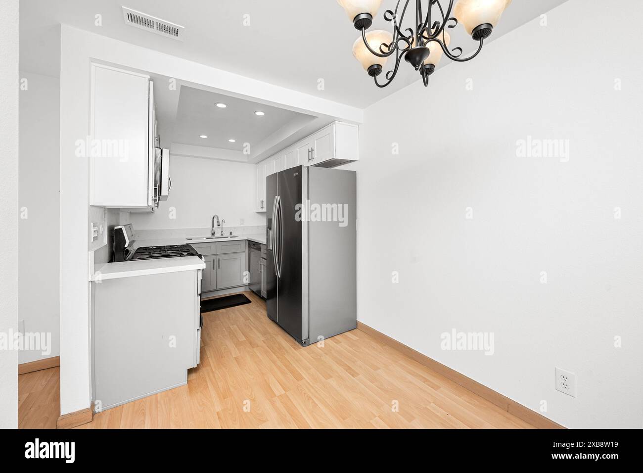 Spacious kitchen with elegant black chandelier Stock Photo