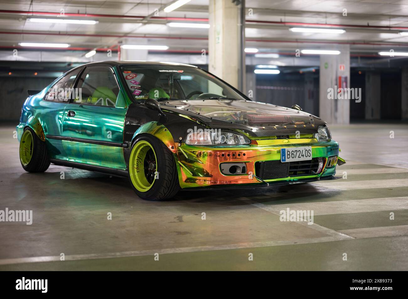 A front view of the Japanese sports car tuned in JDM style Honda Civic EG8 Sedan painted in iridescent changing color Stock Photo