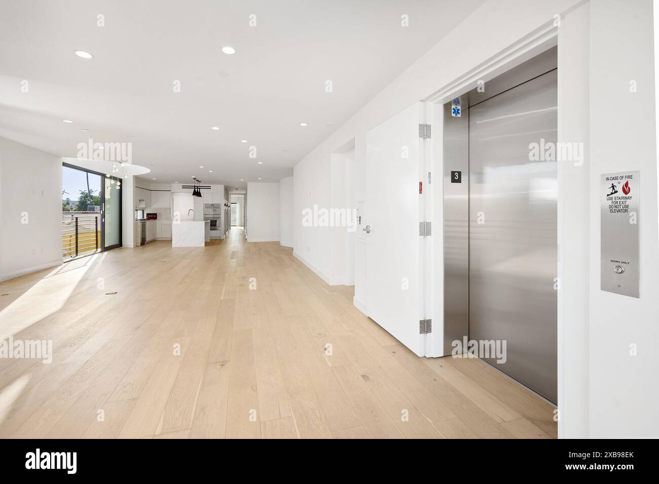 A spacious room with an open layout and light wood flooring. California ...