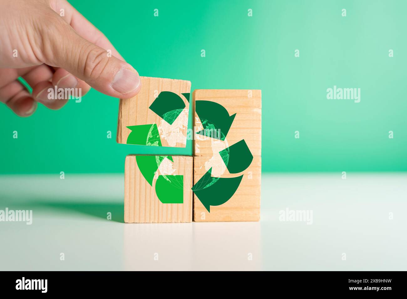 Man hand with a wooden block energy saving concept Recycled waste management, environmentally friendly, save the earth, Earth Day, campaign to raise a Stock Photo