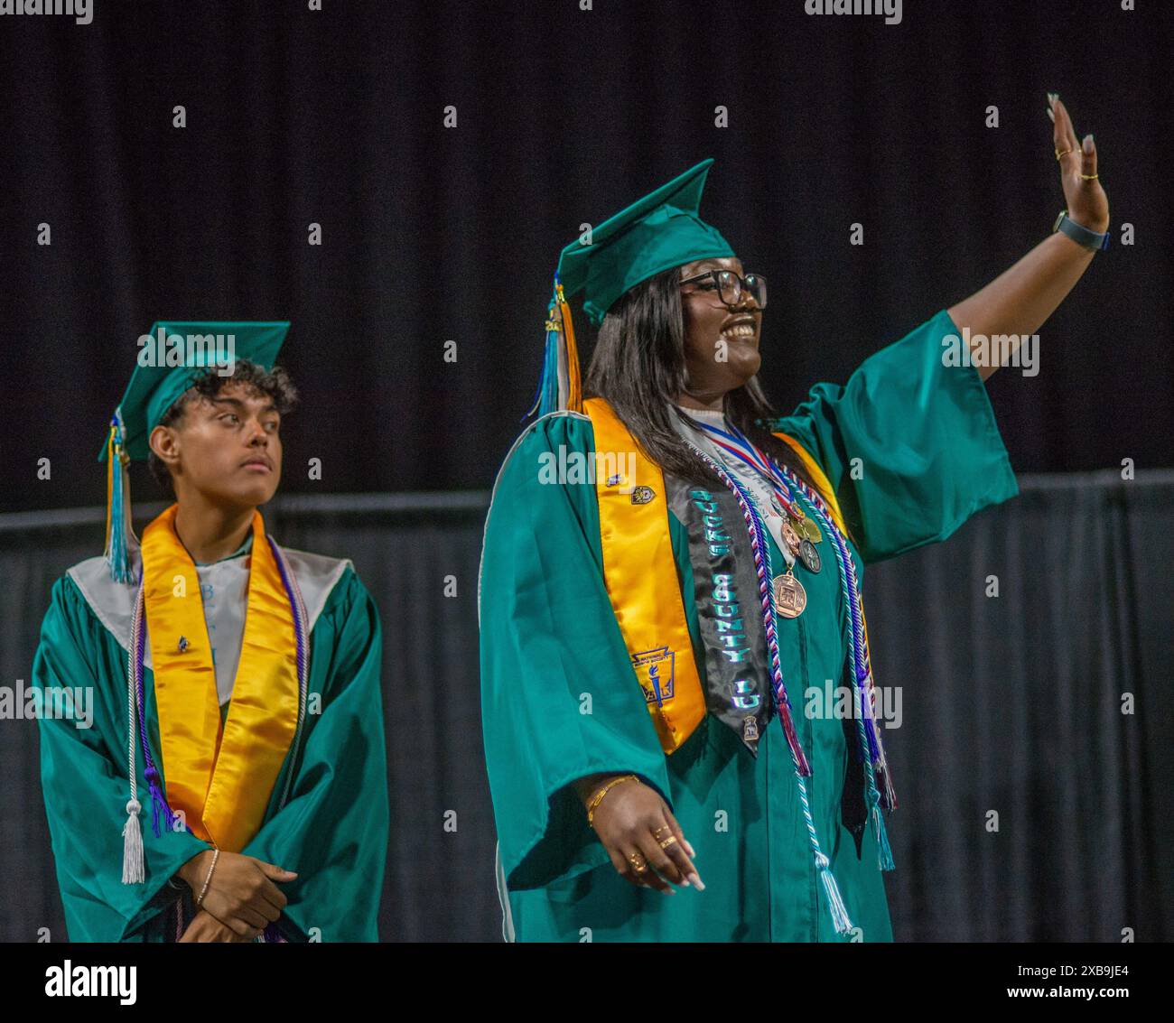 Jeremiah espinoza looks on as class president mandisa kollie right