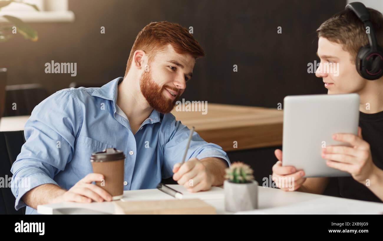 Smart student helping his classmate with homework Stock Photo