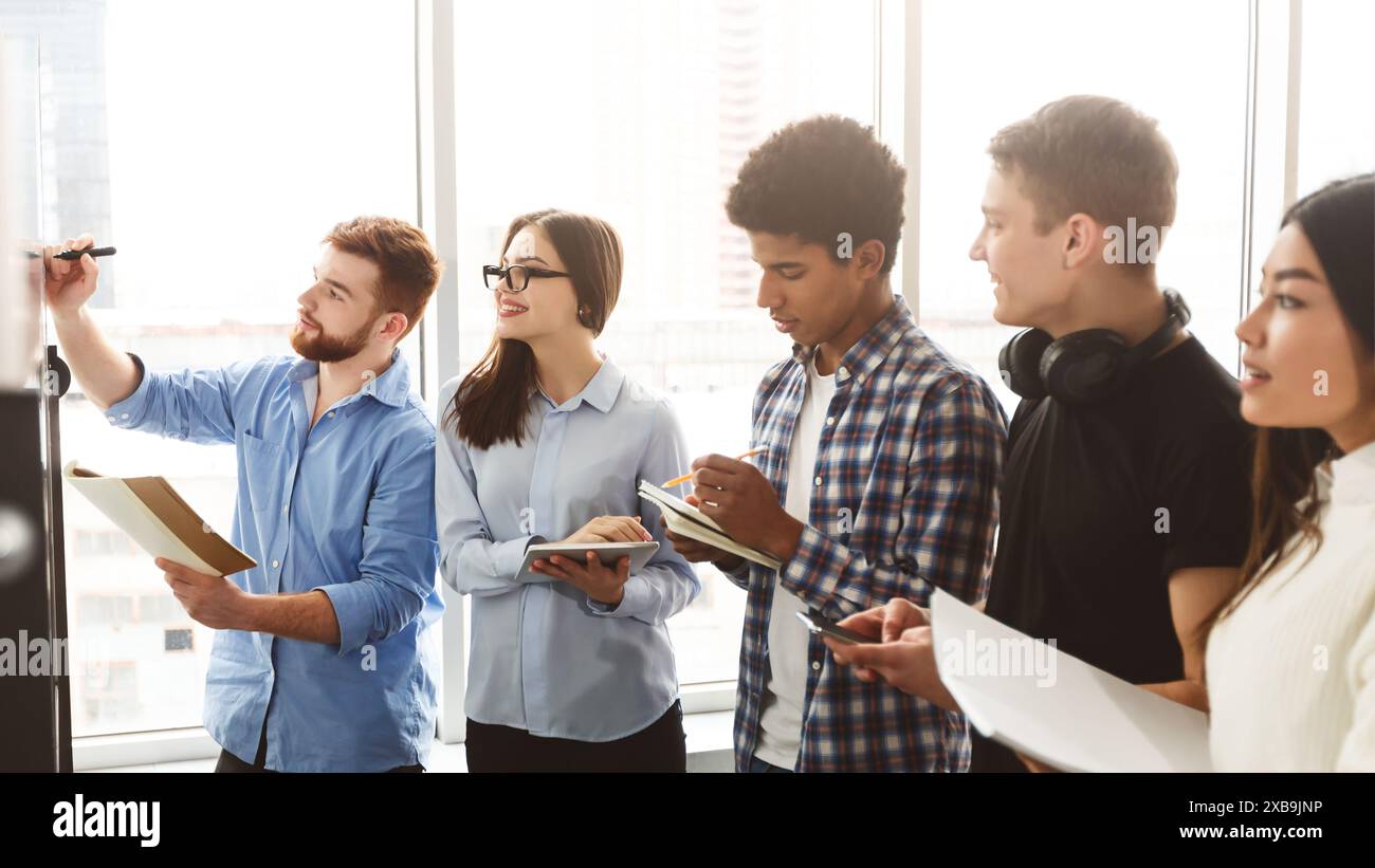 Young Professionals Engaged in a Collaborative Brainstorming Session Stock Photo