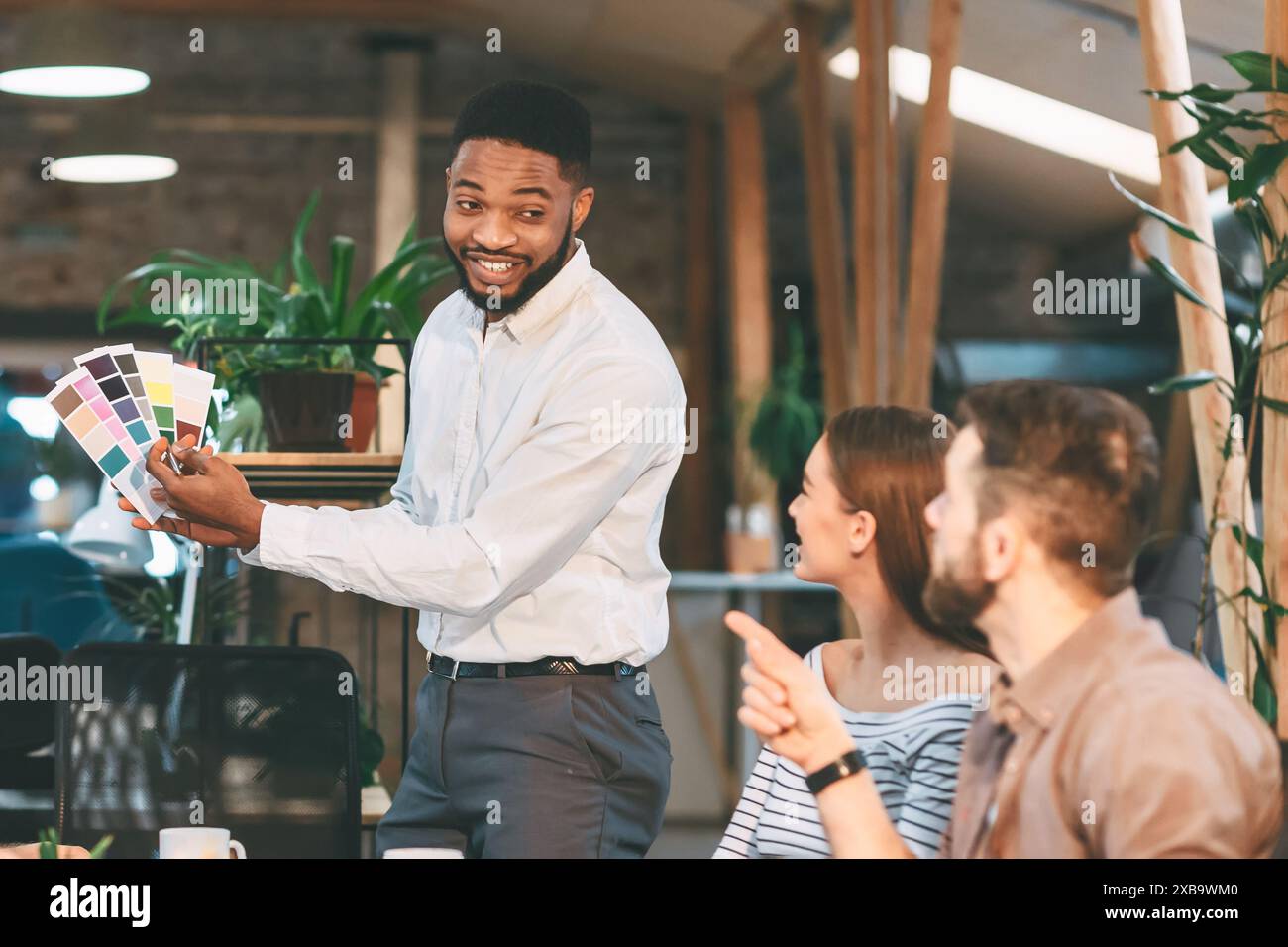 Office Meeting With Colleagues Reviewing Color Swatches in Modern ...