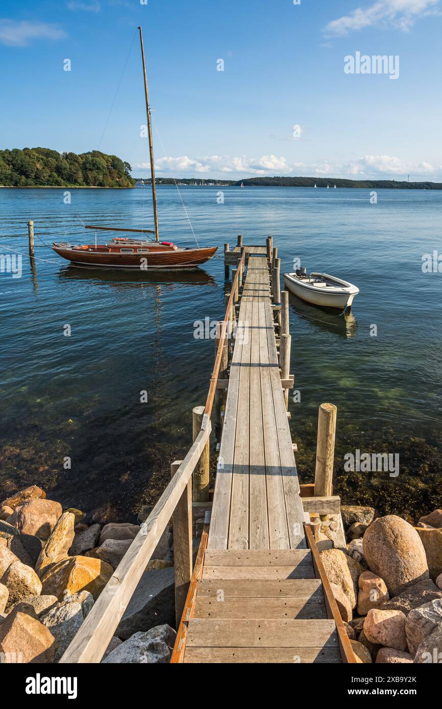 Wooden jetty and boats with view of the Flensburg Fjord and the ...