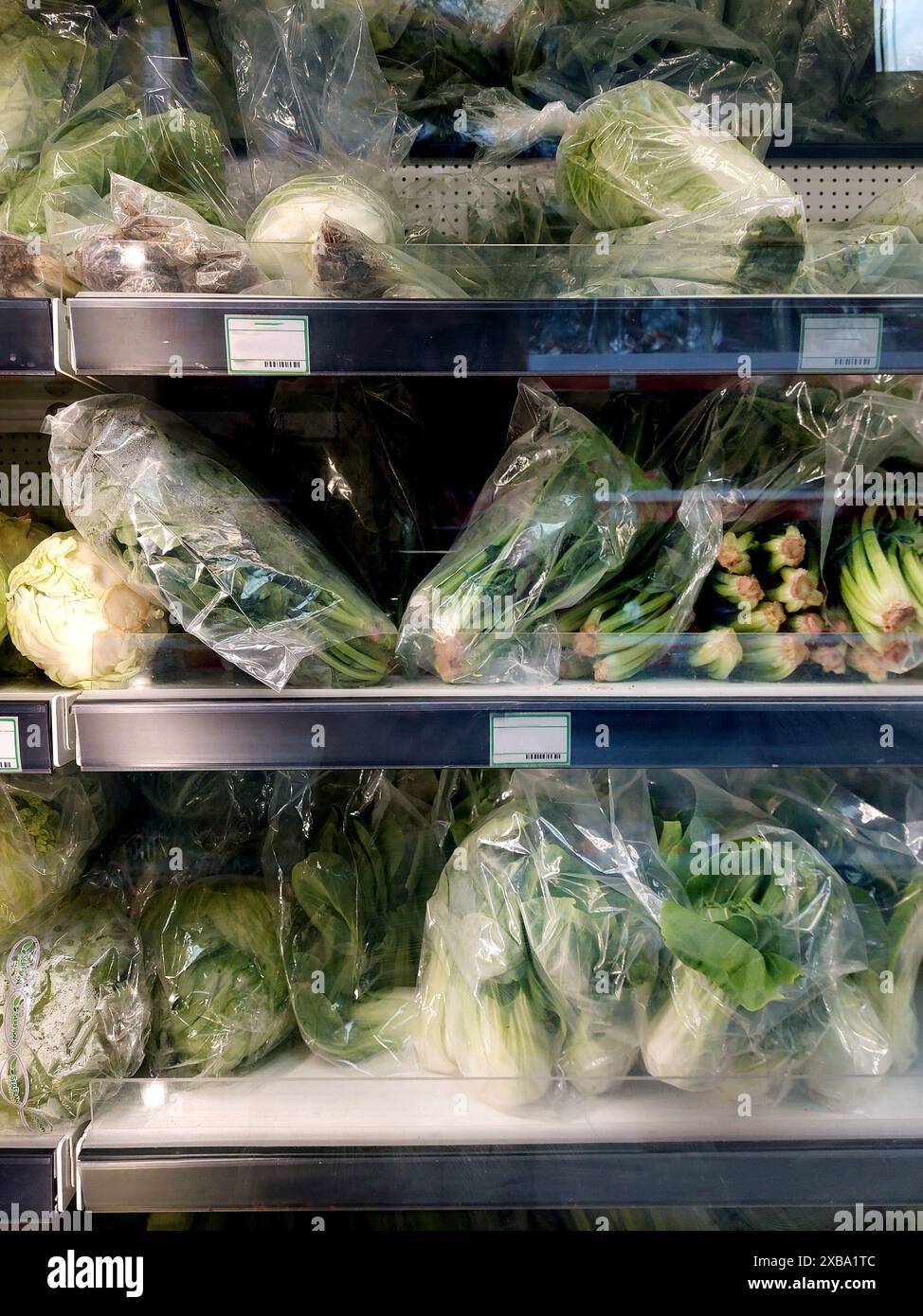 supermarket cooler with vegetables in plastic bags Stock Photo - Alamy