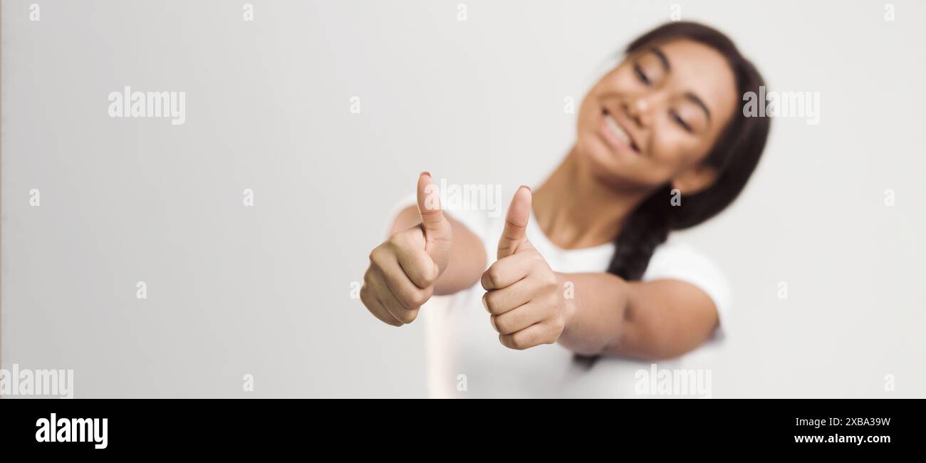Girl Giving Thumbs Up on White Background Stock Photo - Alamy