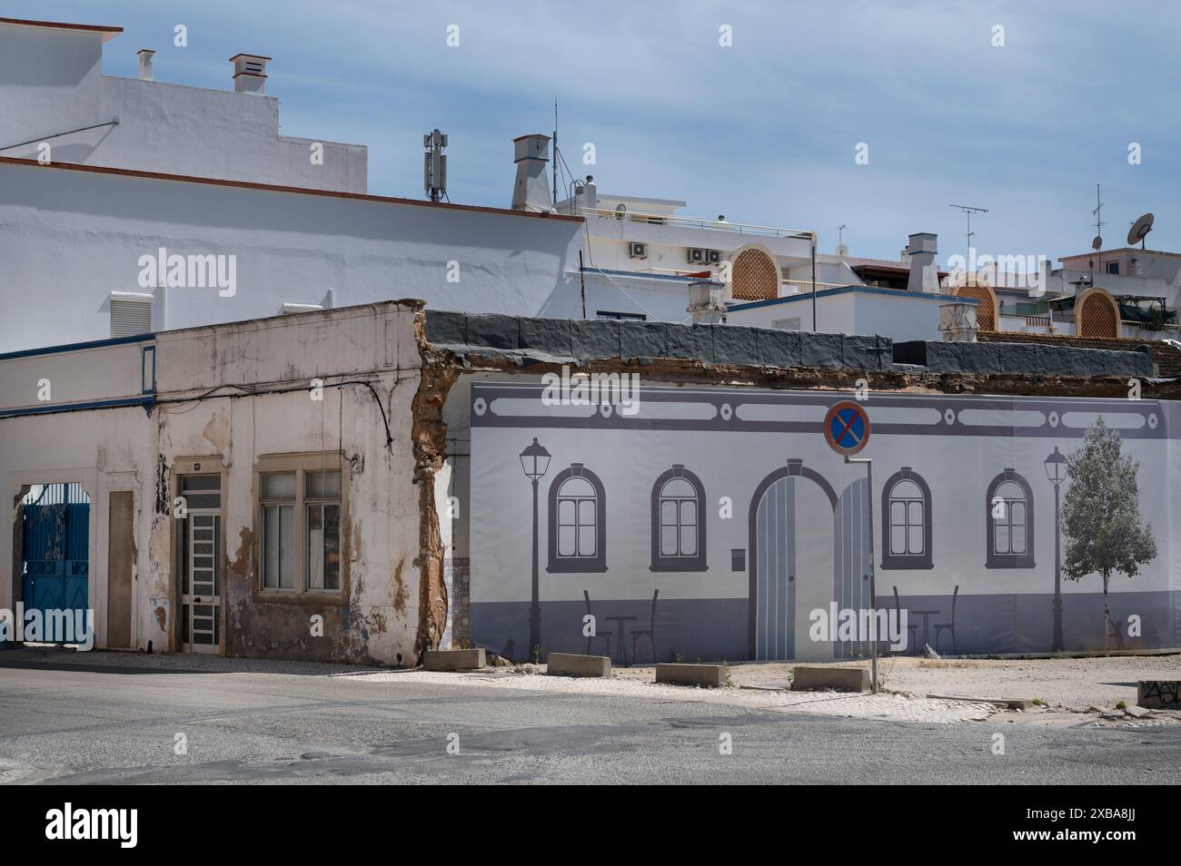 Portugal, Olhao, Algarve  May 2024 A painted facade hides a building site Stock Photo