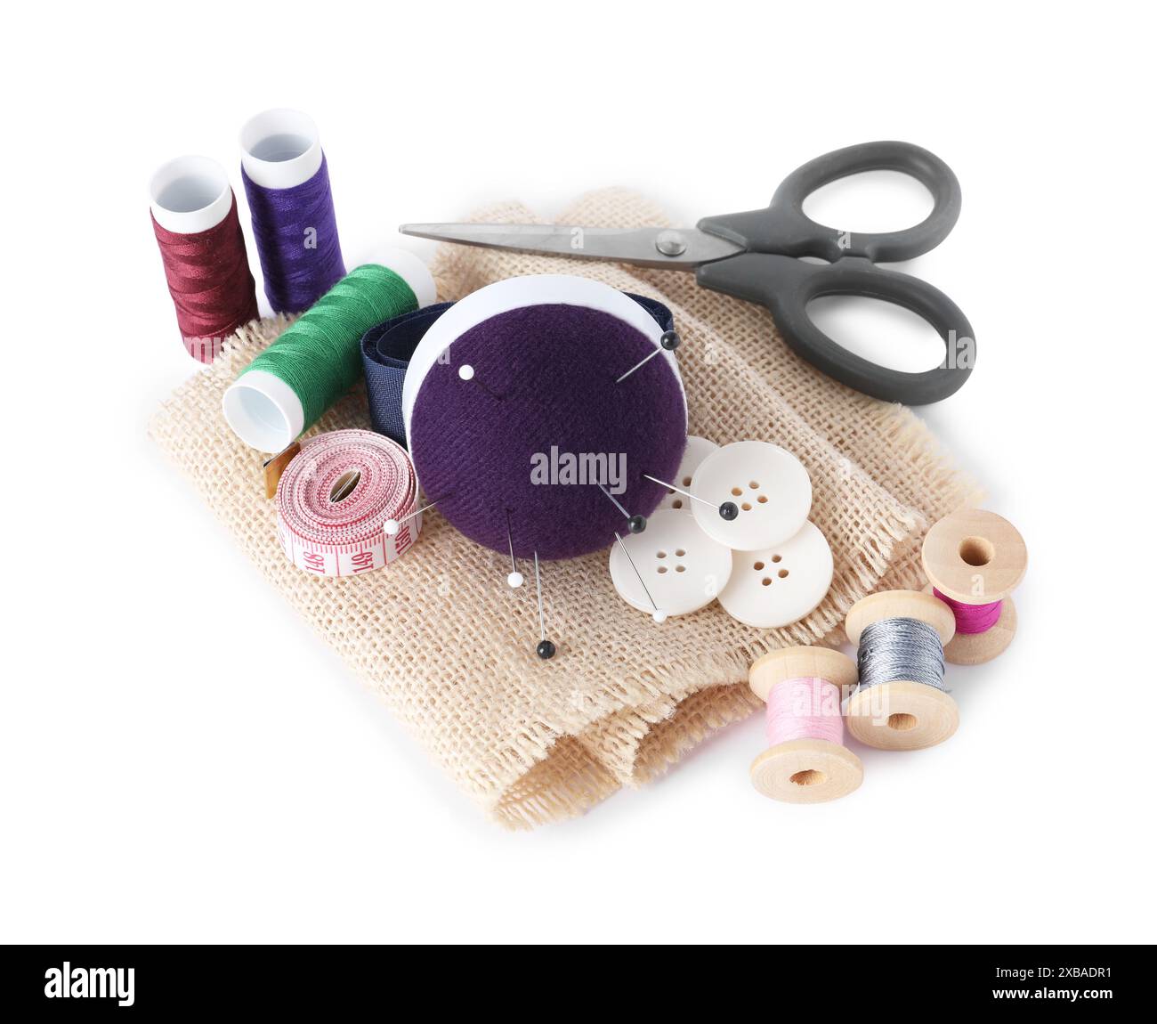 Pincushion, pins and other sewing tools isolated on white Stock Photo — free download