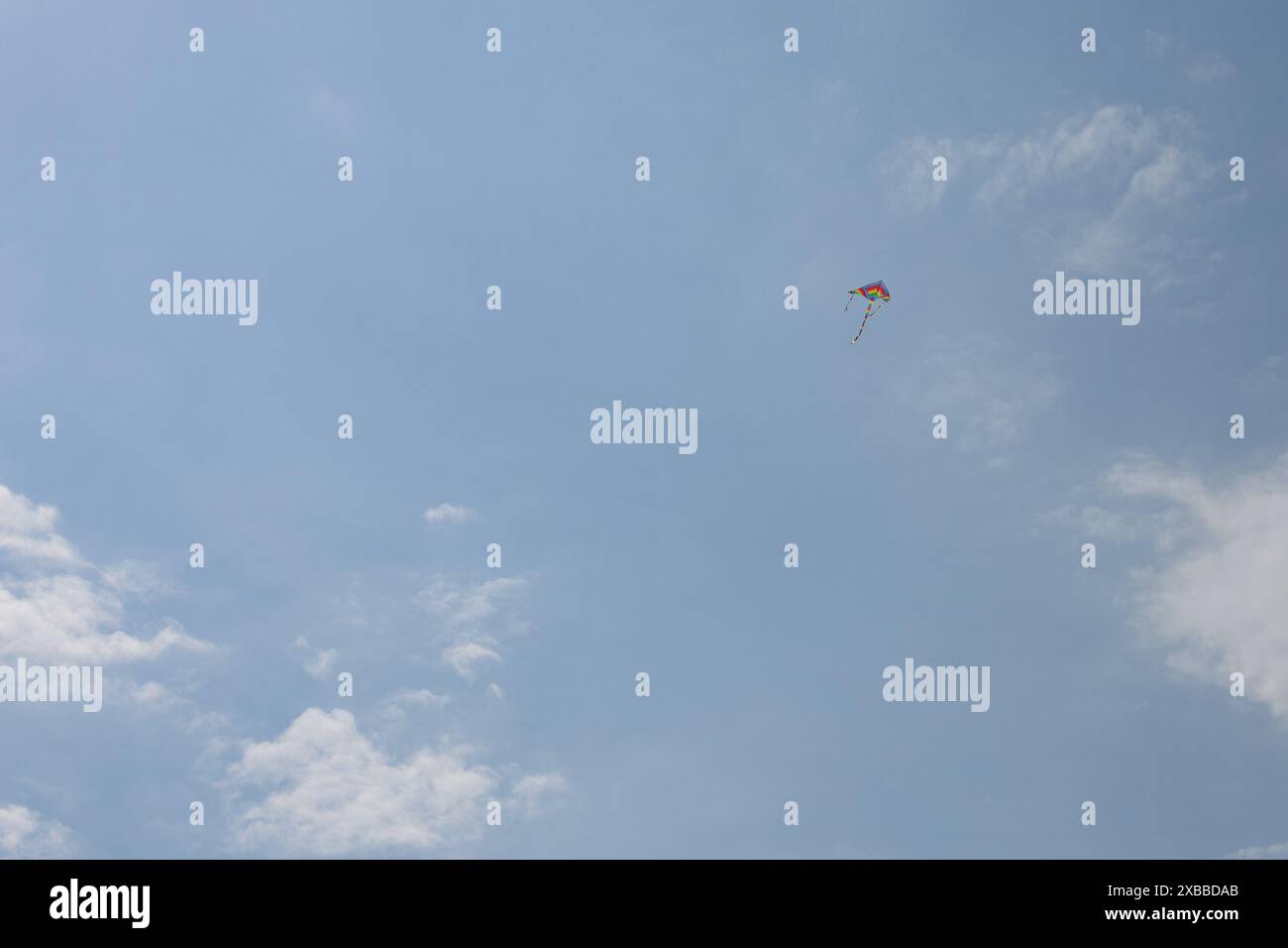 Colorful Kite Flying in Clear Sky Stock Photo