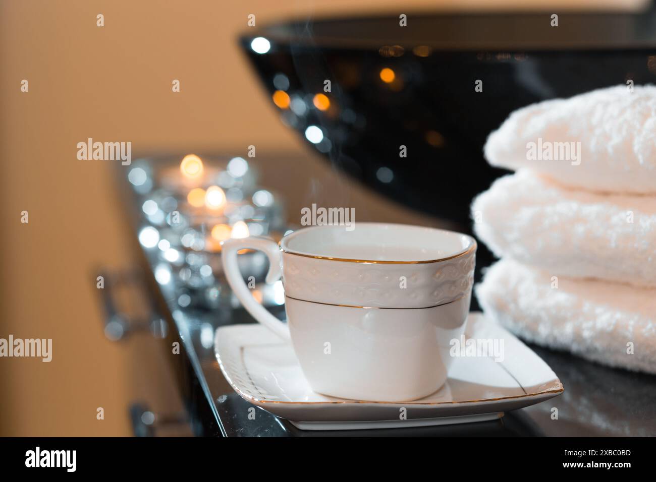 Burning candles and pile of towels in the spa salon Stock Photo - Alamy