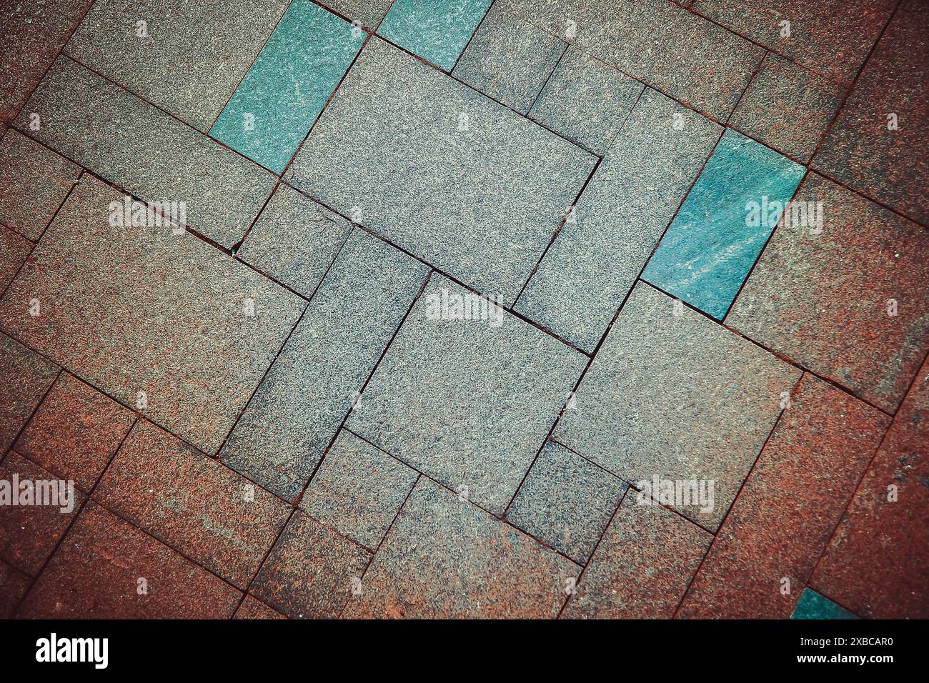 Geometric pattern of pavement tiles in blue and brown tones, creating a textured urban flooring design, background image Stock Photo