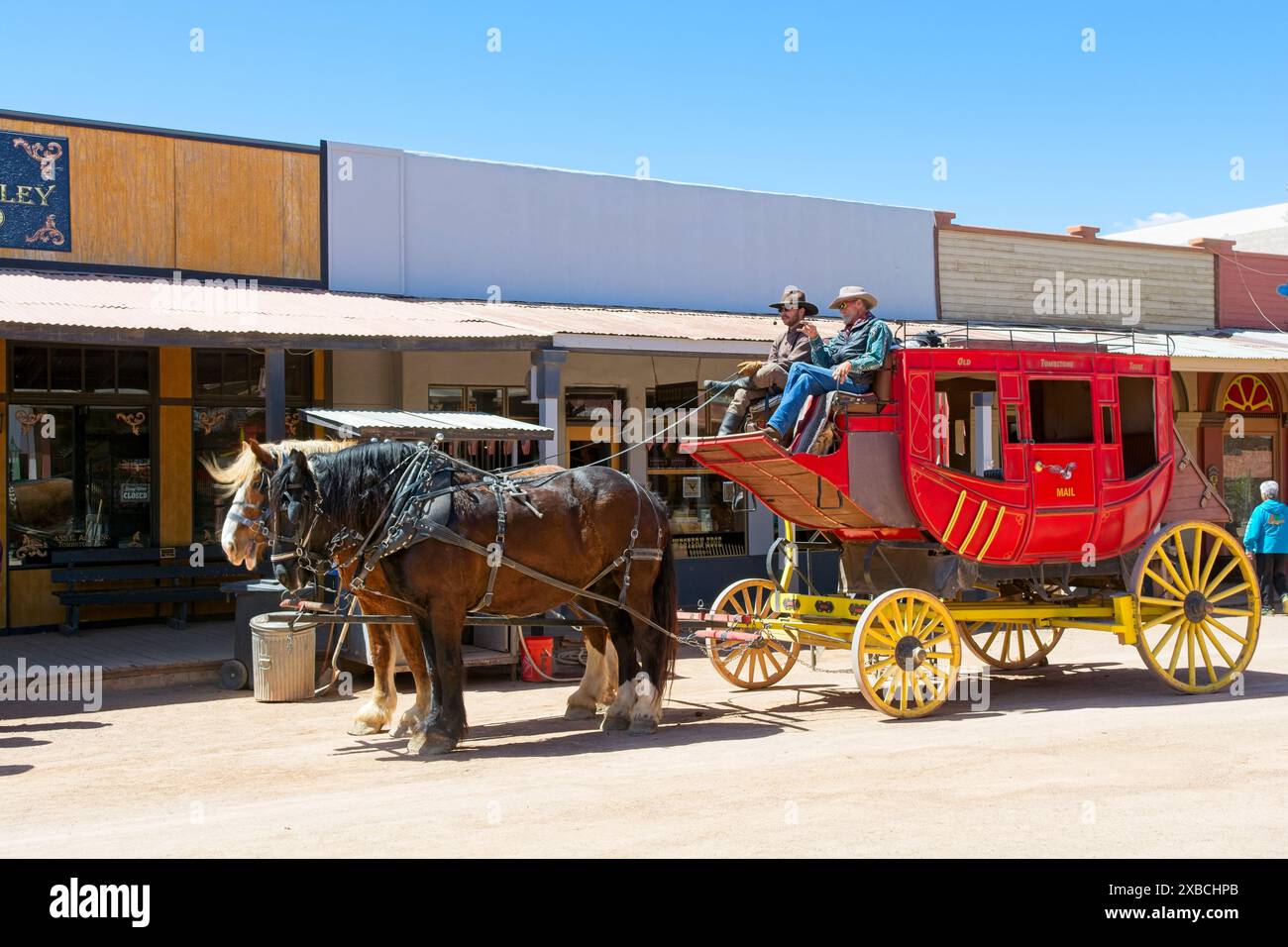 Horse drawn stagecoach on dirt road lined with territorial style old west storefronts in Tombstone Arizona — April 2024 Stock Photo