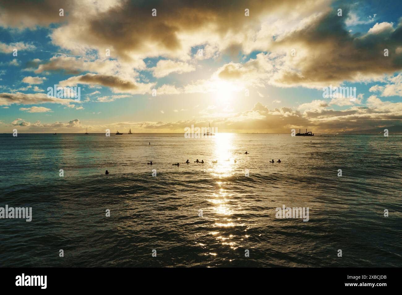 The sun slowly descends on the horizon, casting a warm glow over the ...