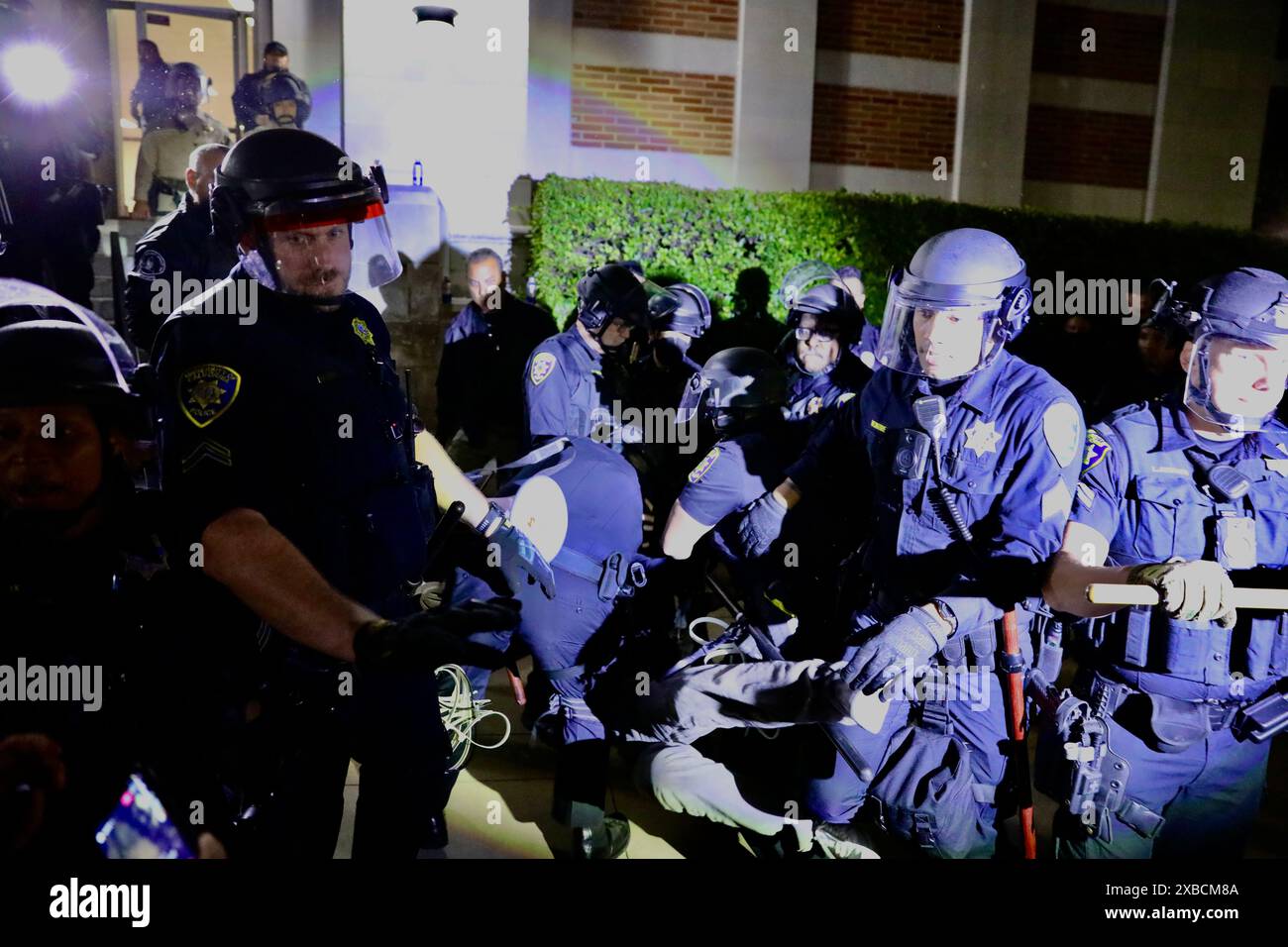 Los Angeles, USA. 11th June, 2024. Police officers detain a pro ...