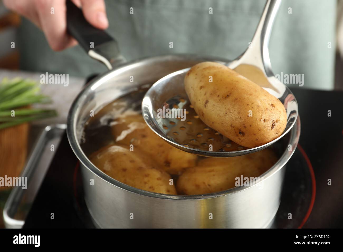 Woman taking boiled potato hi-res stock photography and images - Alamy