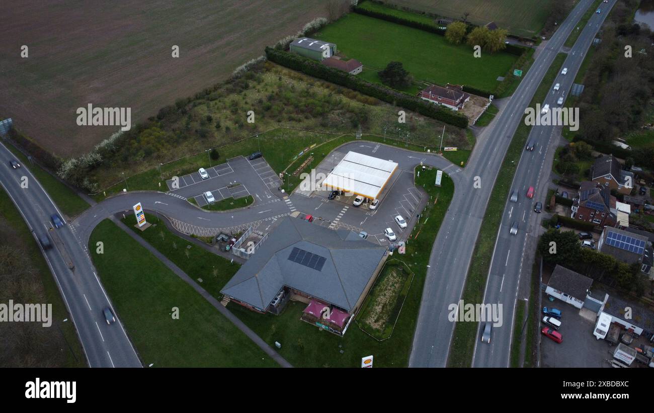 Aerial view of buildings, highway, field, and large factory Stock Photo